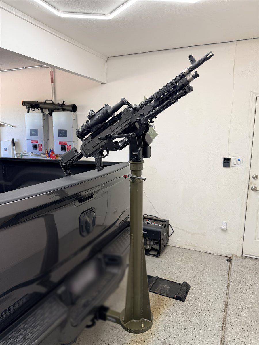 Belt-fed machine gun on a pedestal mount